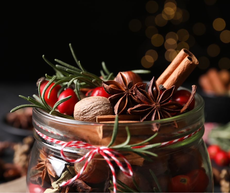 A potpourri blend featuring pine needles, cinnamon sticks, and dried red berries.