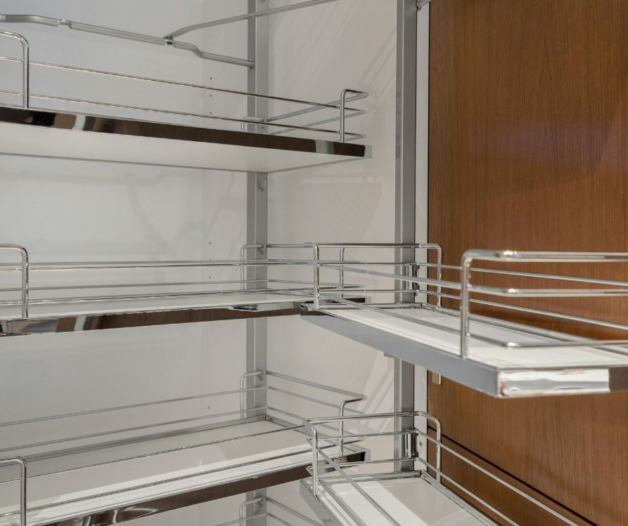 A Pantry with chrome shelving inside and on the wooden door.