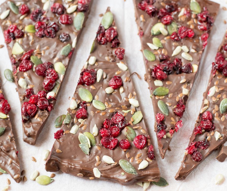 Chocolate bark topped with sunflower seed, pumpkin seeds, pomegranate seeds and dried berries.
