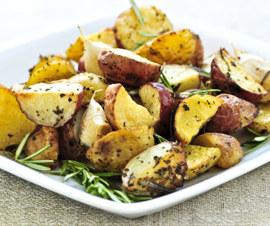 Cooked new potatoes topped with fresh rosemary.