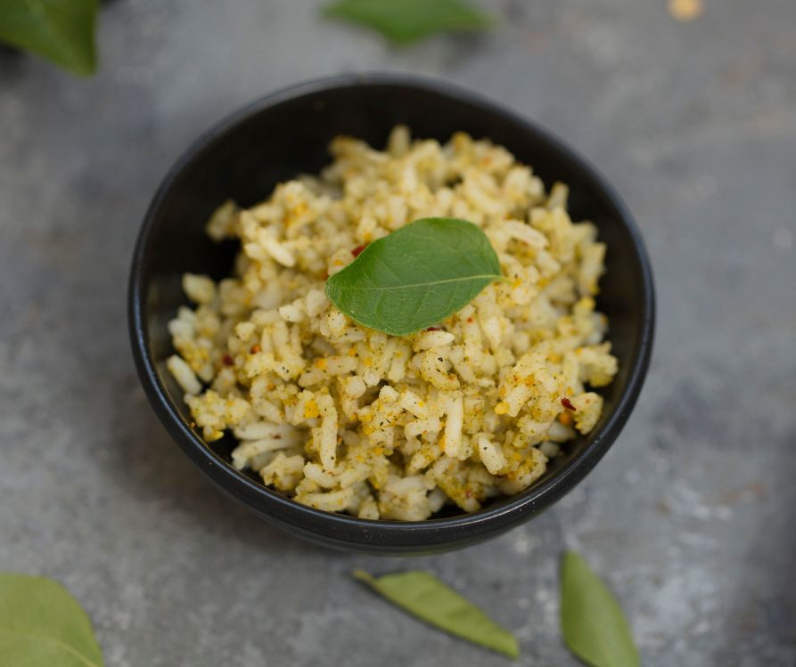 Curry leaf rice, spices powder on a grey counter top.