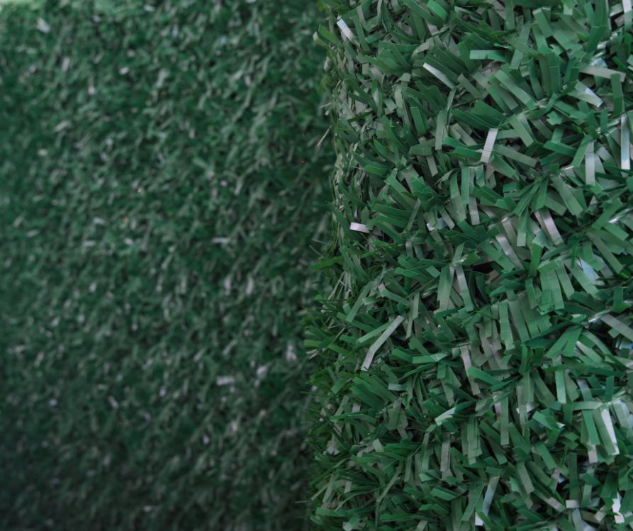 An inexpensive roll of faux green privacy hedge.