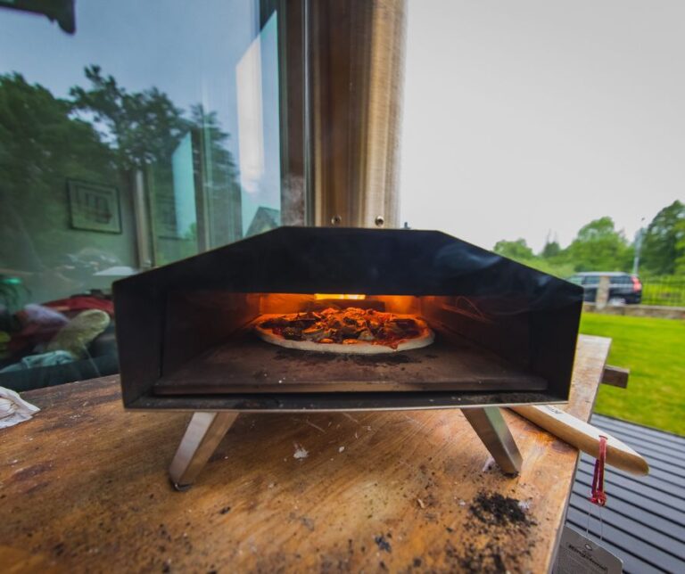 Portable pizza outdoor oven on a patio table.