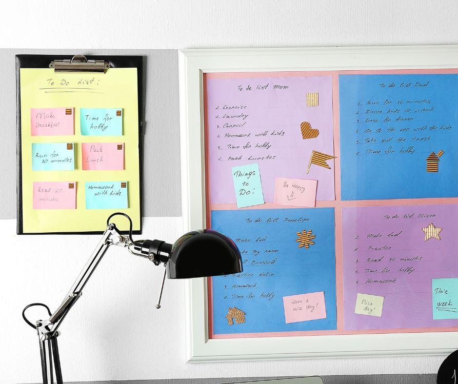 An organized board with color coded to do lists and messages for each family member.