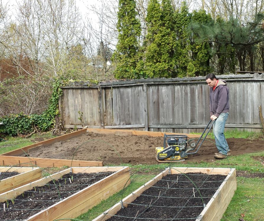 Mark Brittenburg tamping down foundation soil.