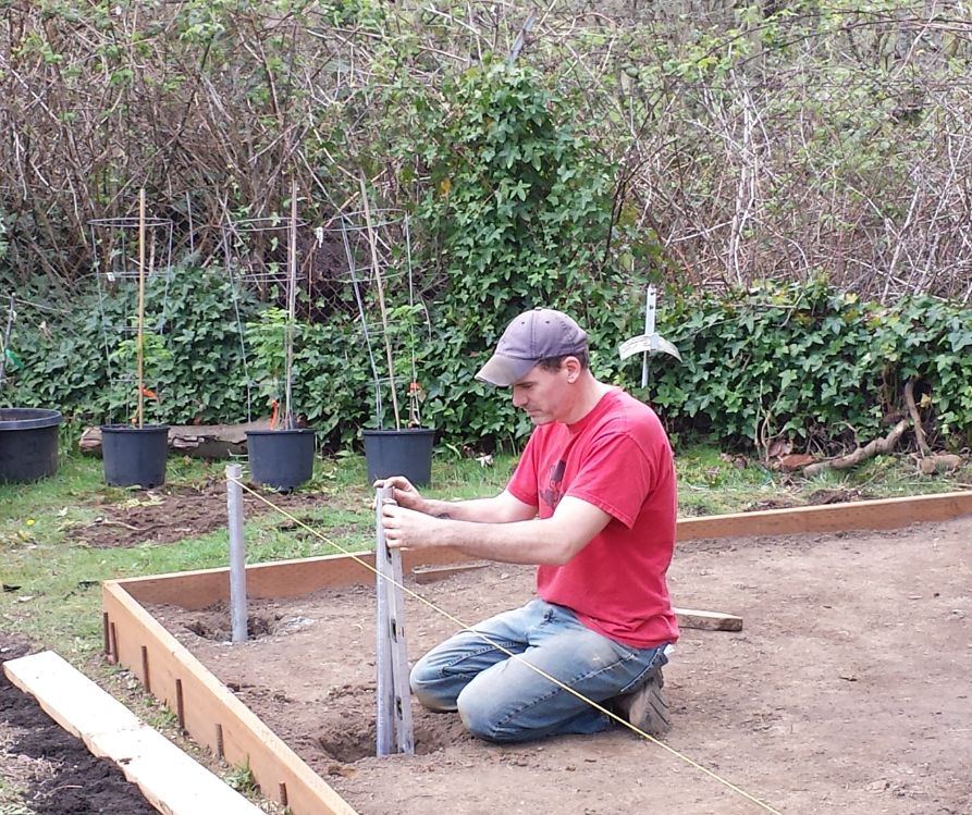 Mark Brittenburg leveling the greenhouse footings.