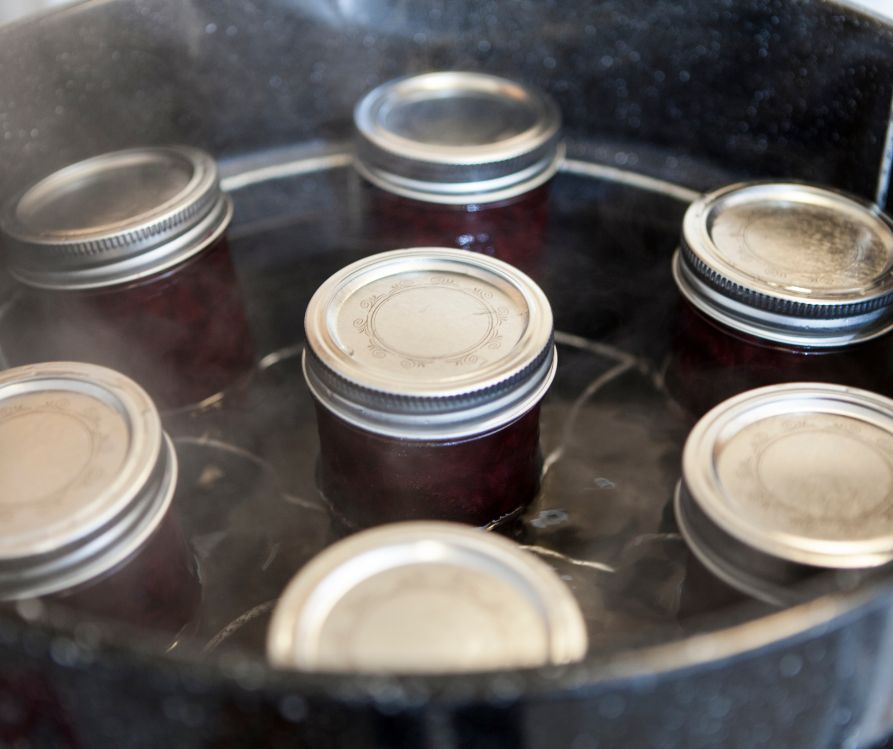 Small jelly jars in a home canner.