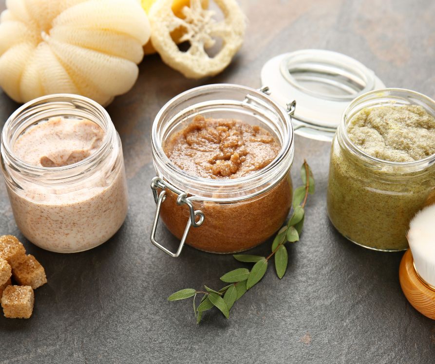 Assortment of Sugar Scrubs on Dark Table