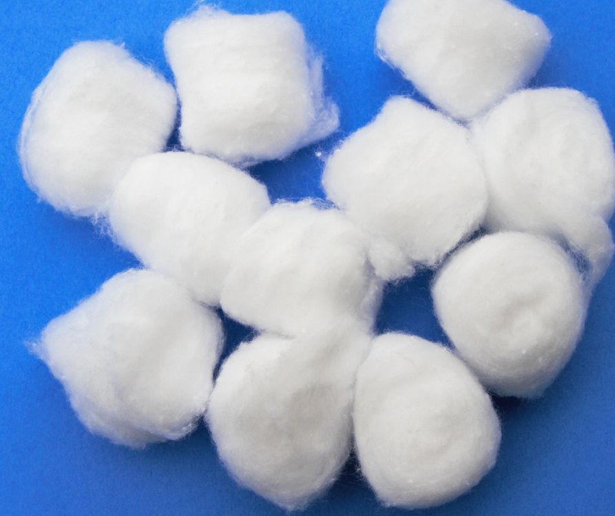 White cotton balls on a blue background.