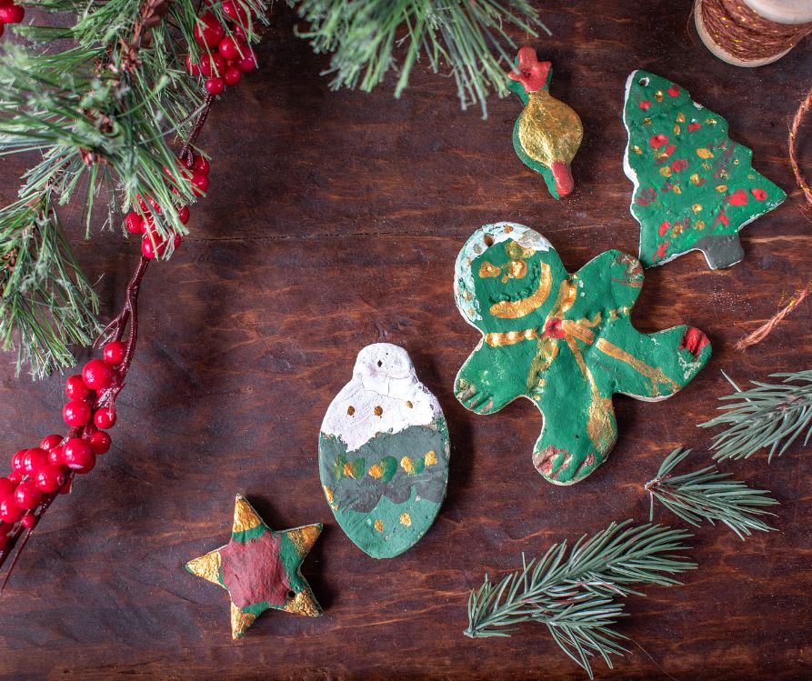 Painted Christmas salt dough decorations. Star, light bulb, gingerbread man and a Christmas tree.