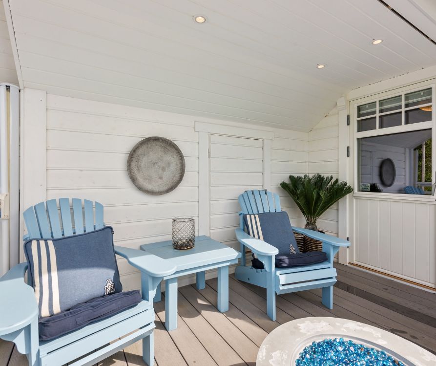 Coastal theme outdoor patio decor including chairs and tables in light blue.