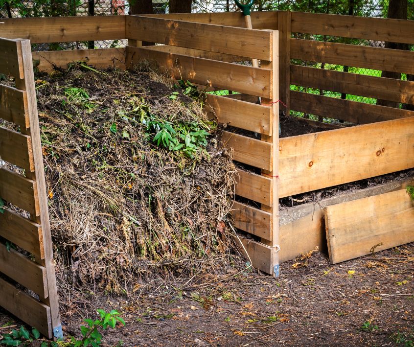 A backyard garden compost system made with scrap wood.