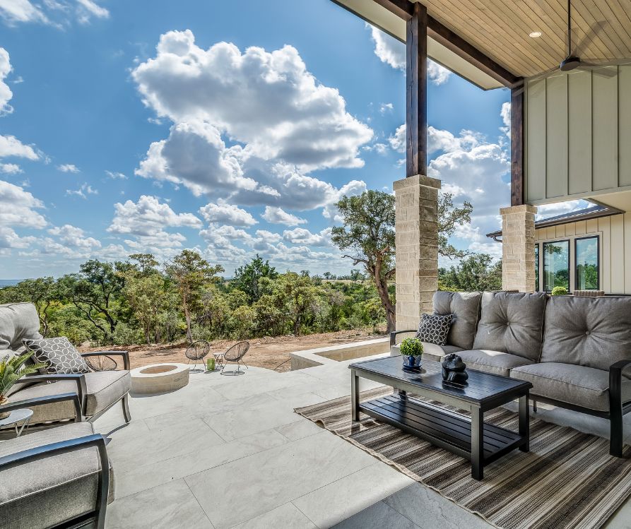 Desert view from a covered patio with comfortable furniture set.