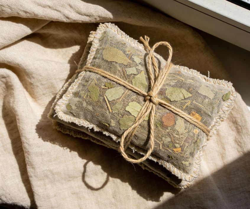 Potpourri sachets filled with dried herbs tied with twine.