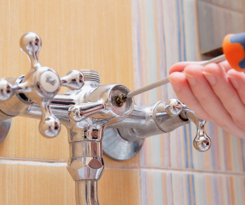 A person replacing faucet washer To stop water leak.