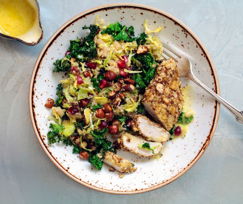 Quinoa, brussels sprouts, crispy kale and hazelnuts salad with dukkah crusted chicken