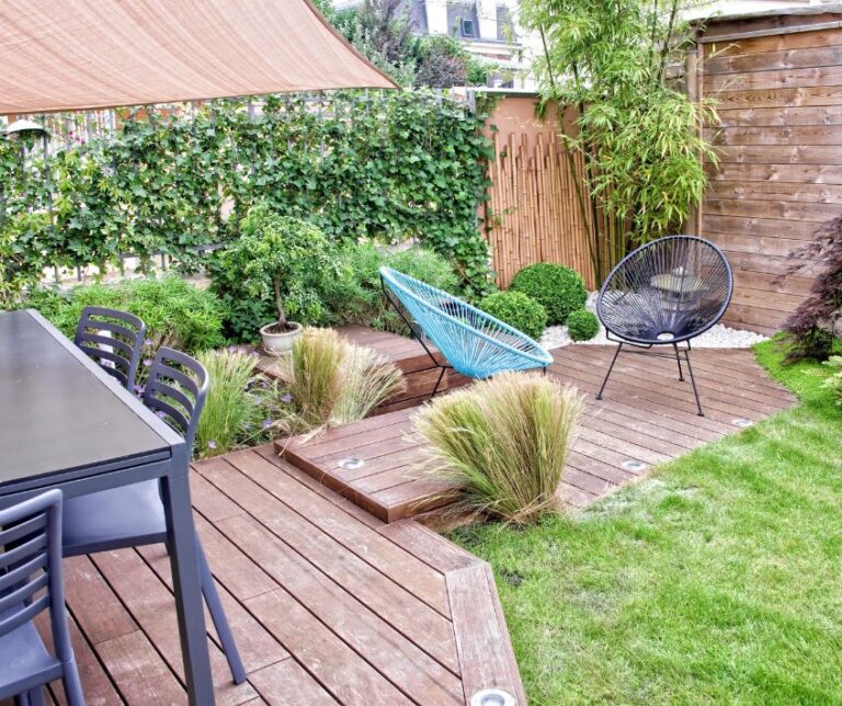 Private terraced deck seating areas, lush green garden, shielded by privacy screens.