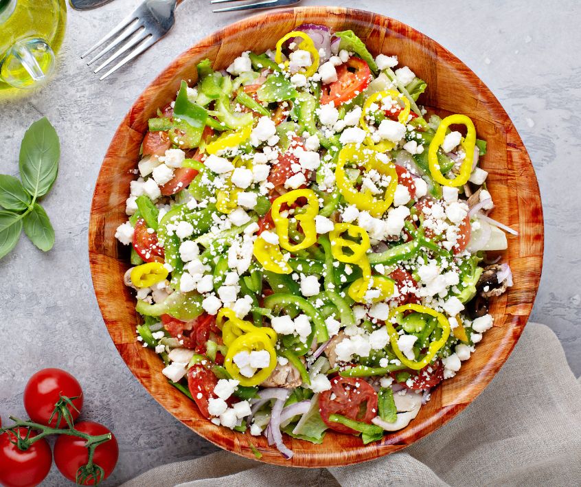 Greek salad topper with pepperoncini and feta.