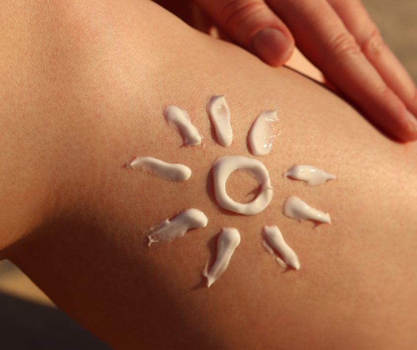 Sunscreen in a sun design on a person's skin.