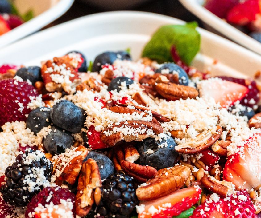 Spinach salad with berries, feta and candied pecan.