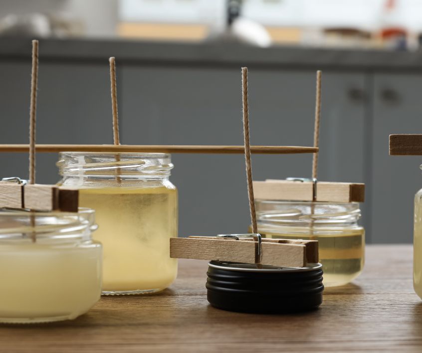 Candles setting in reused glasses jars and tins.