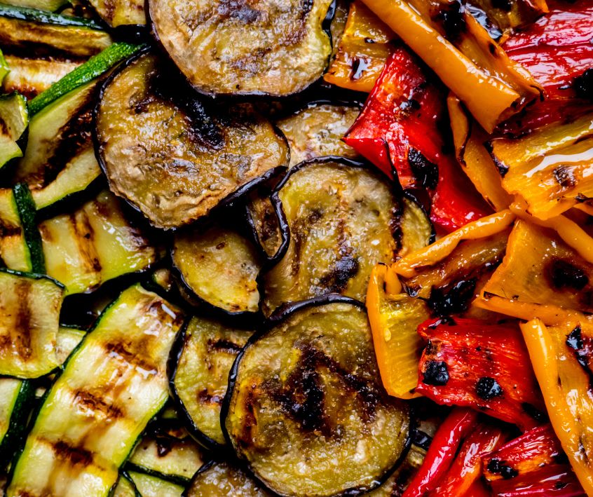 Grilled zucchini, eggplants, red and orange bell peppers.