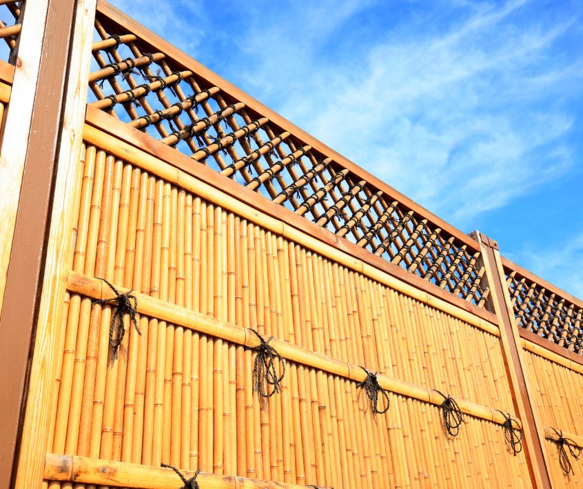 Bamboo fence panels with lactic sections at the top.