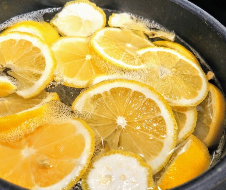 Slices of bright yellow lemons in a large pot.